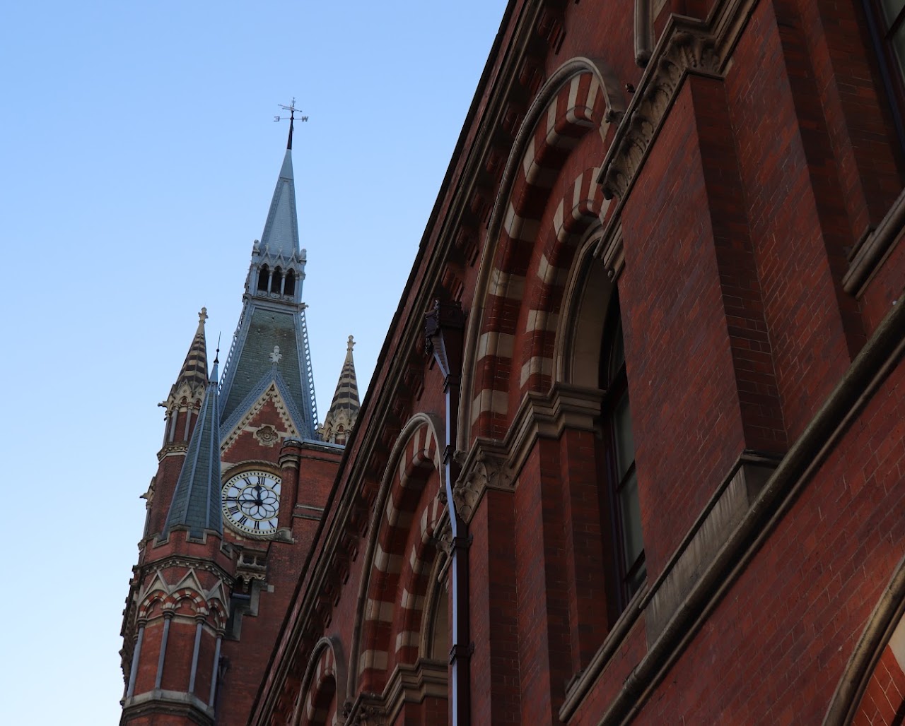 Gothic red-brick architecture rising against a blue sky