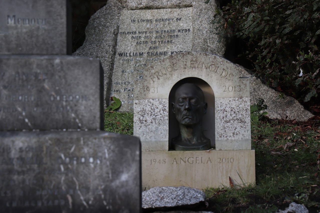 A sculpted bust set into a memorial stone